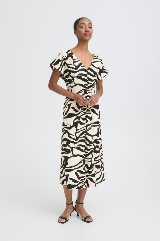 Woman wearing a zebra print dress on a white background
