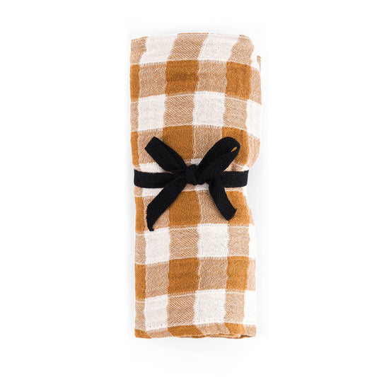 Plaid napkin with a black ribbon on a white background