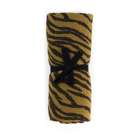 Folded fabric with tiger stripe pattern on a white background