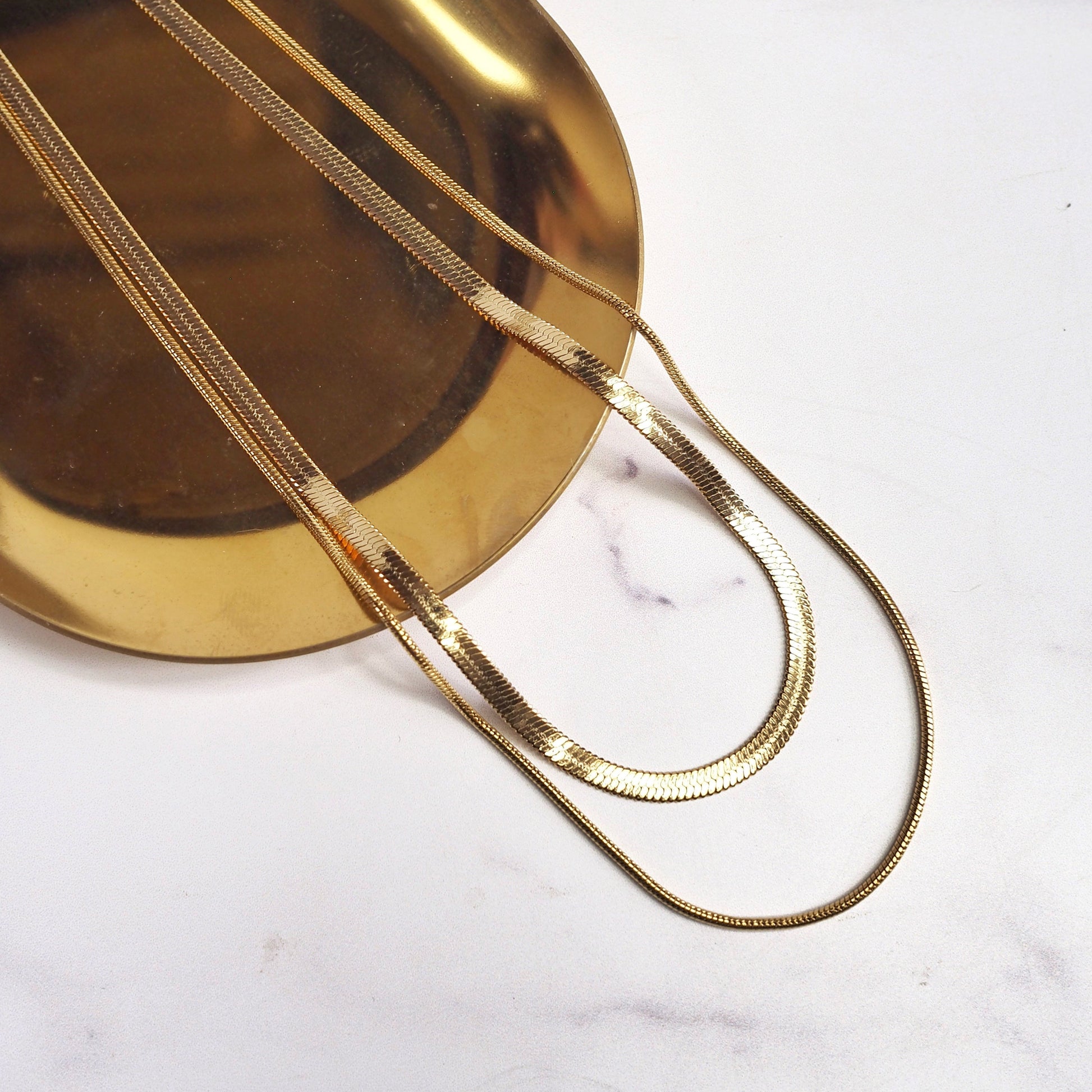 Gold chain necklace on a white background