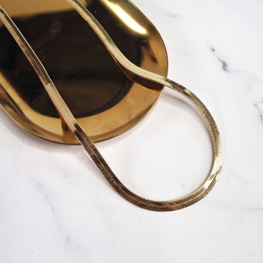 Gold necklace on a marble surface