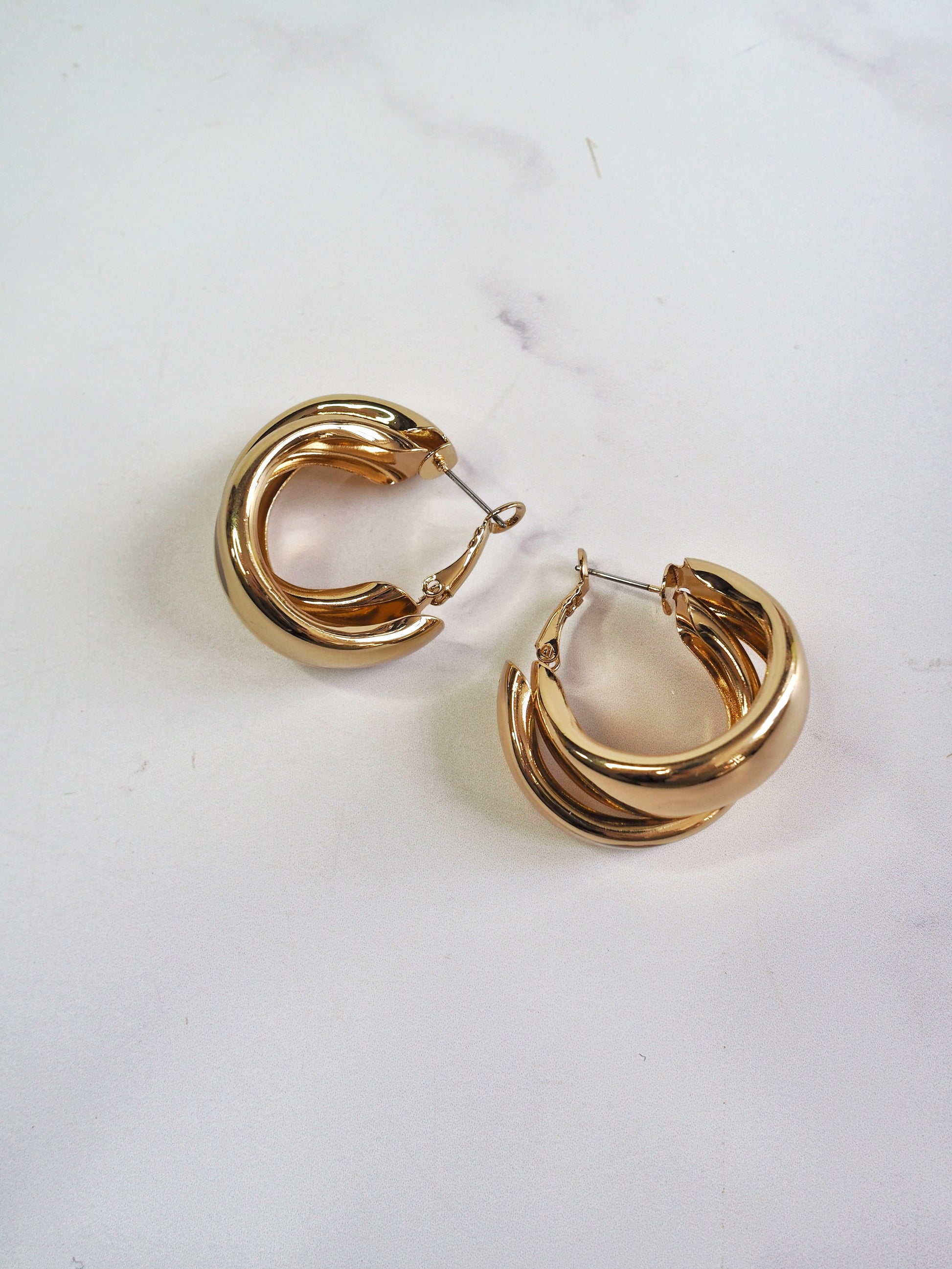 Gold hoop earrings on a white background
