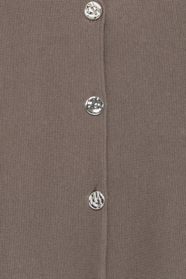 Close-up of a brown fabric with silver buttons on a matching background