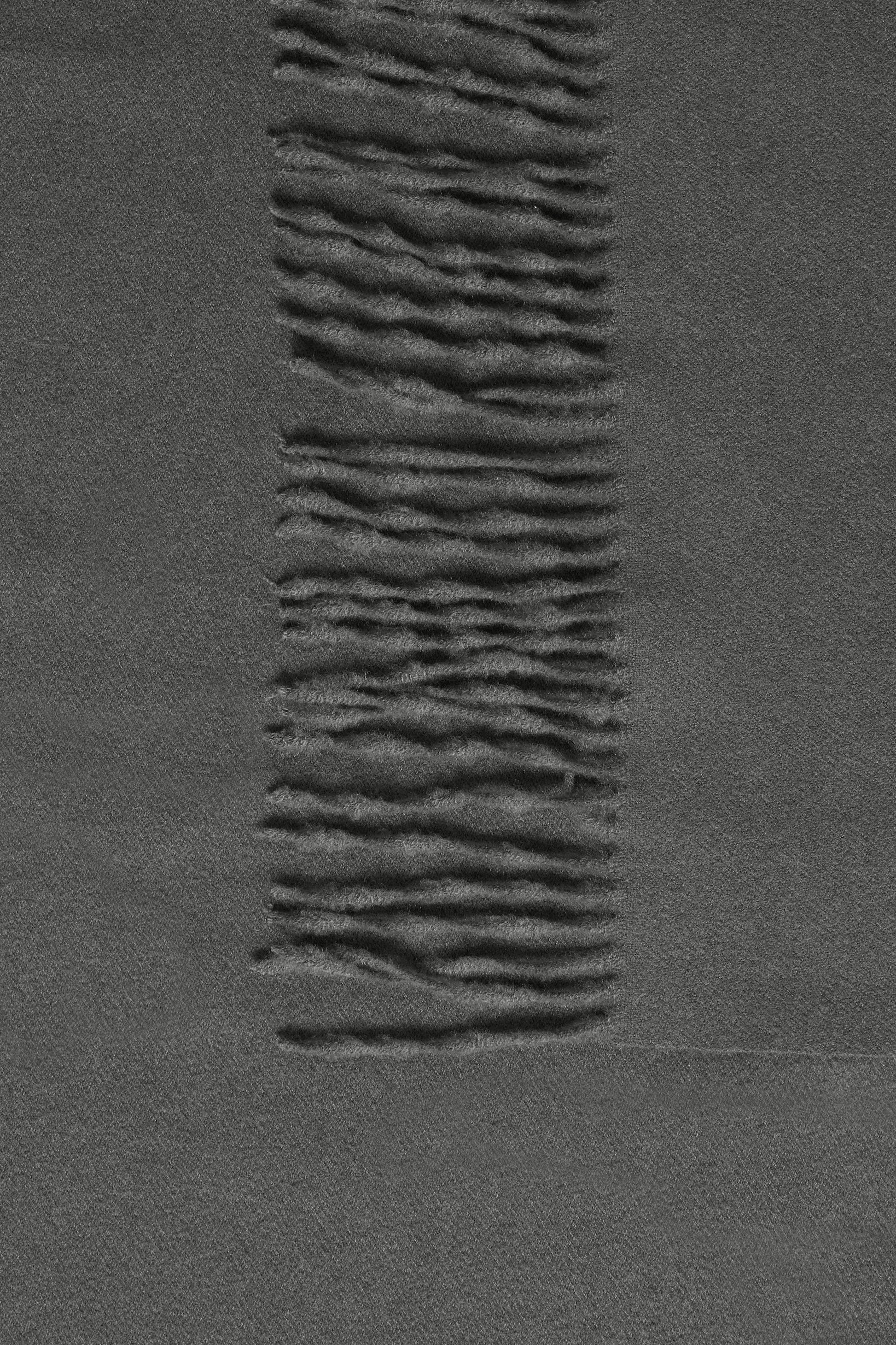 Textured dark gray surface with wavy pattern