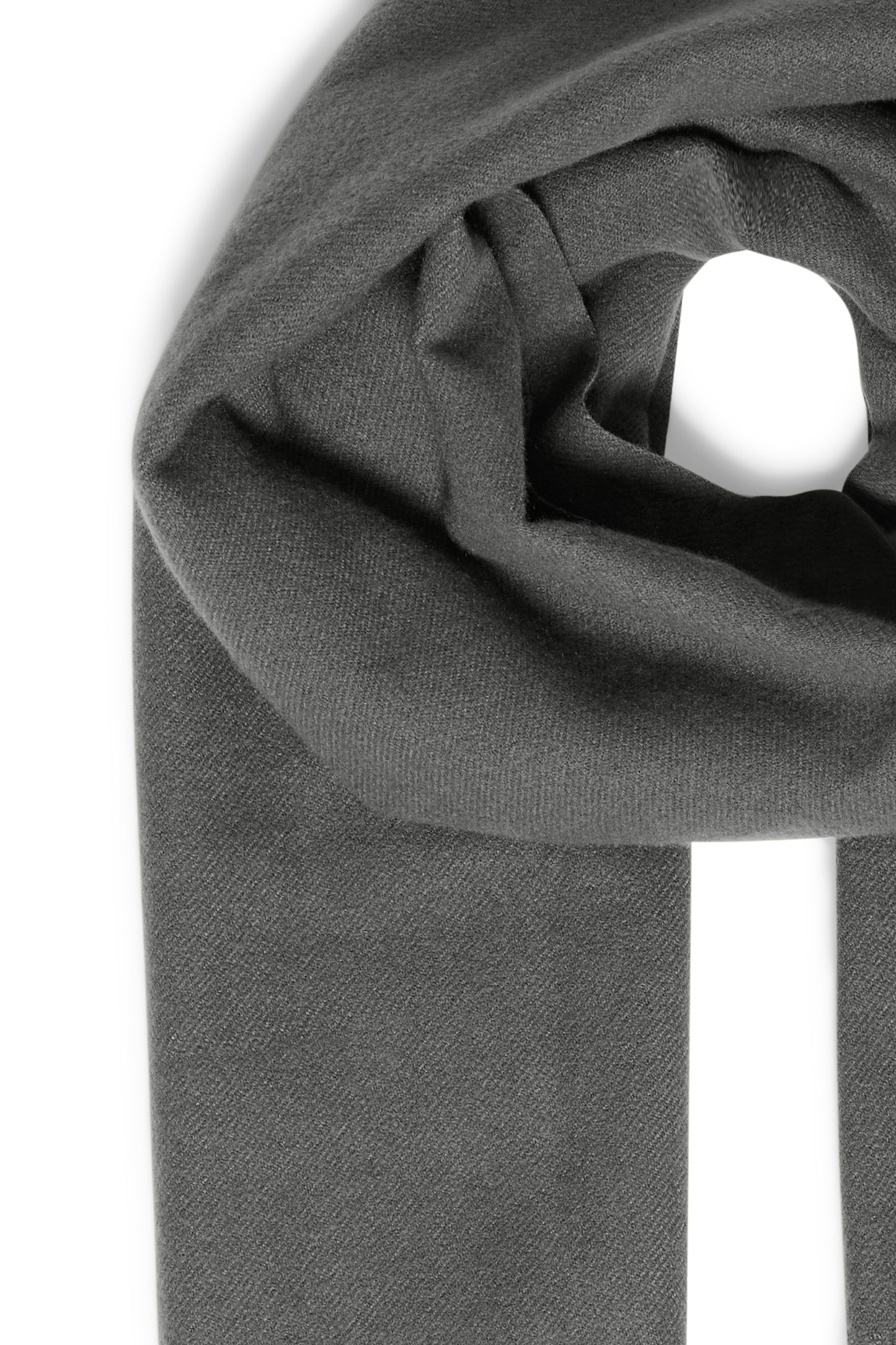 Close-up of a gray fabric roll with a white candle inside on a white background