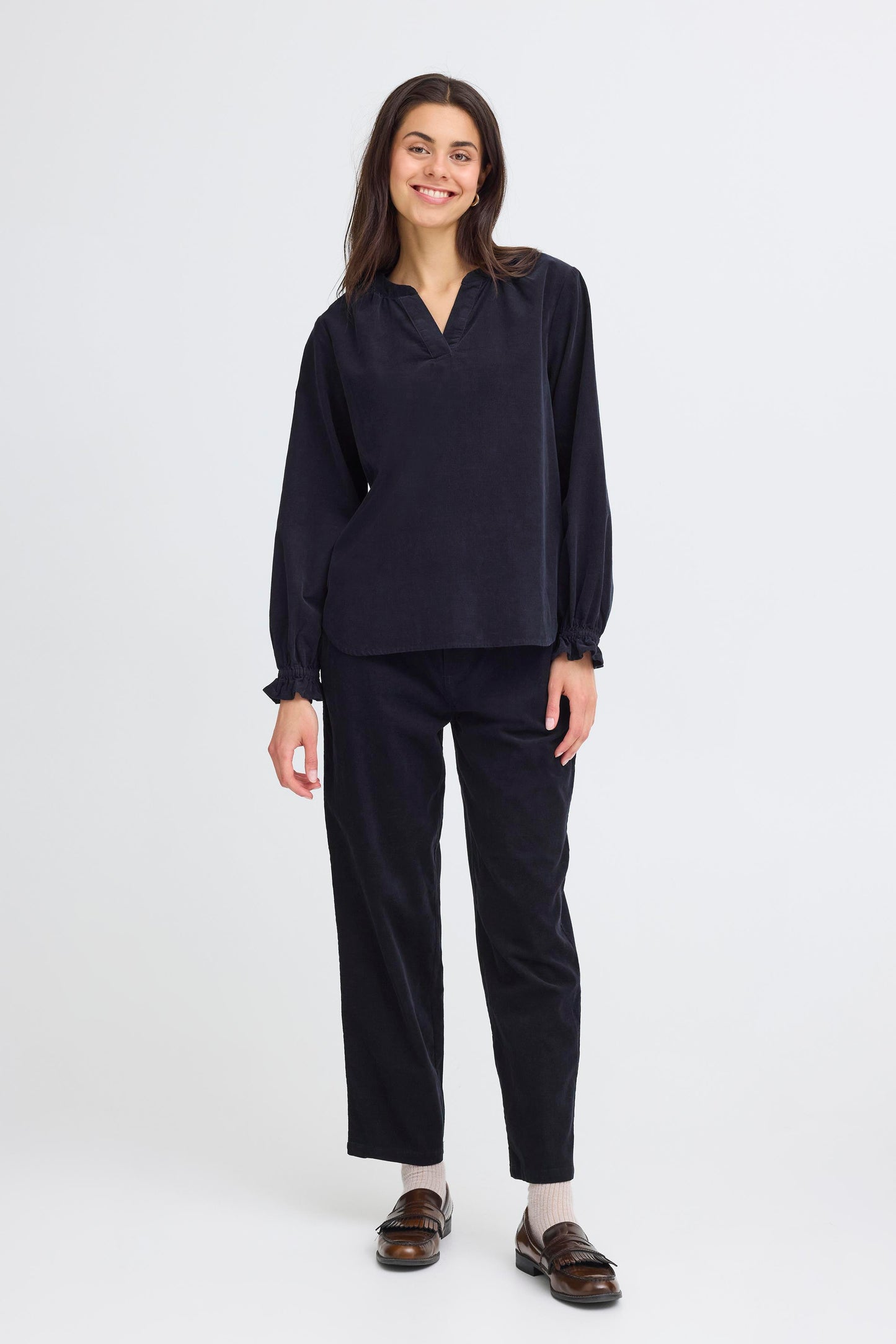 Woman wearing a black outfit on a white background