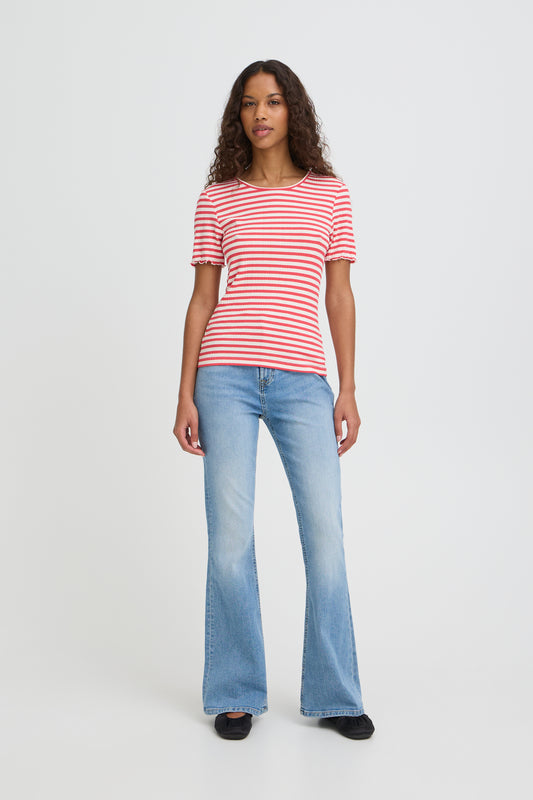 Woman wearing a red and white striped shirt and blue jeans on a white background