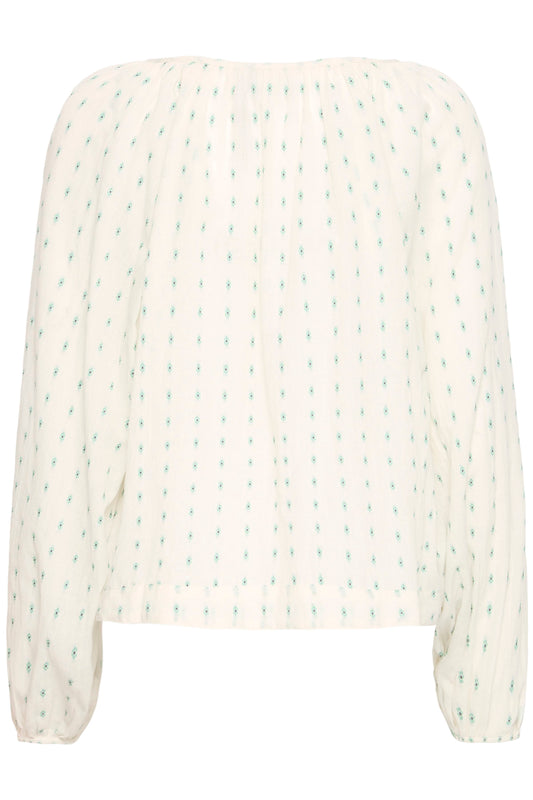 White blouse with green pattern on a white background