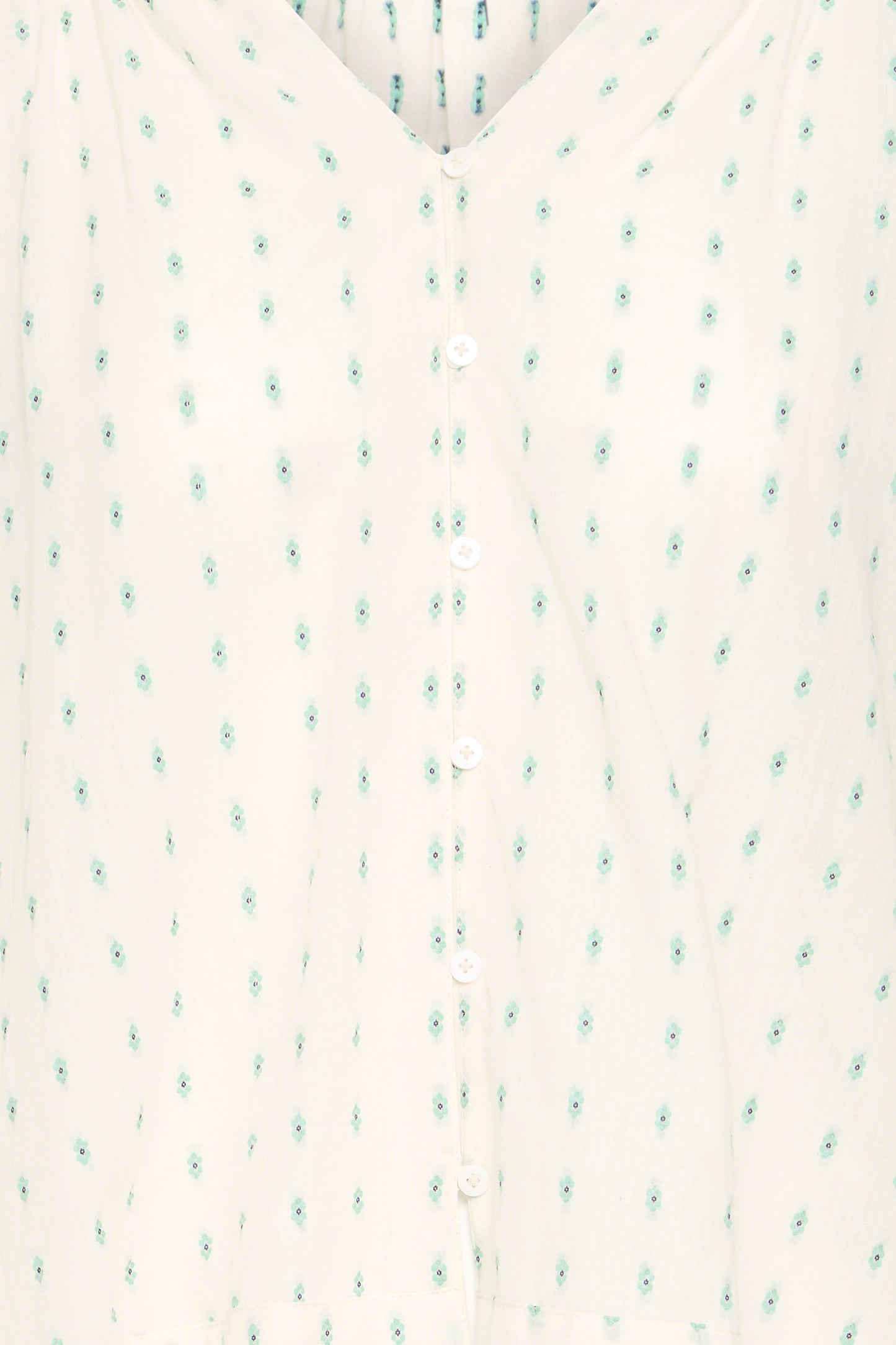 Close-up of a textured fabric with small green patterns on a white background