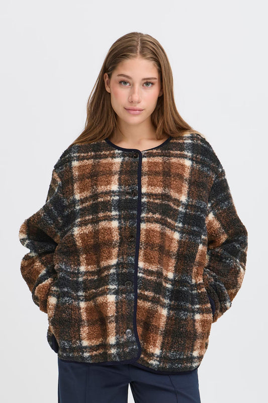 Woman wearing a plaid sweater on a white background