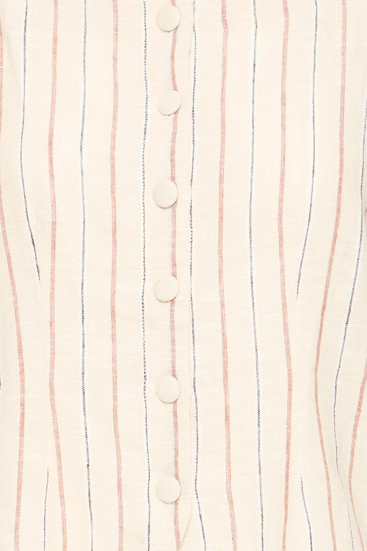 Close-up of a fabric with vertical stripes and buttons on a light background
