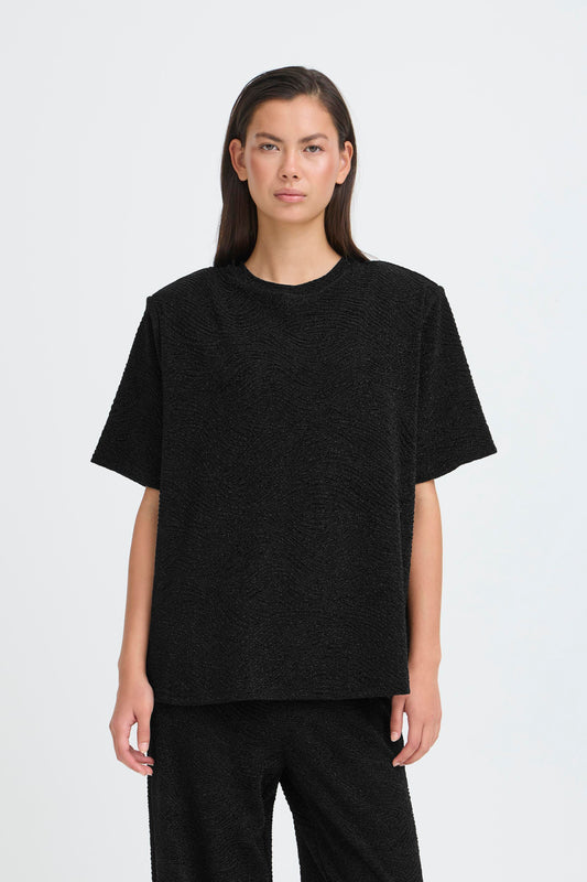 Person wearing a black t-shirt on a white background