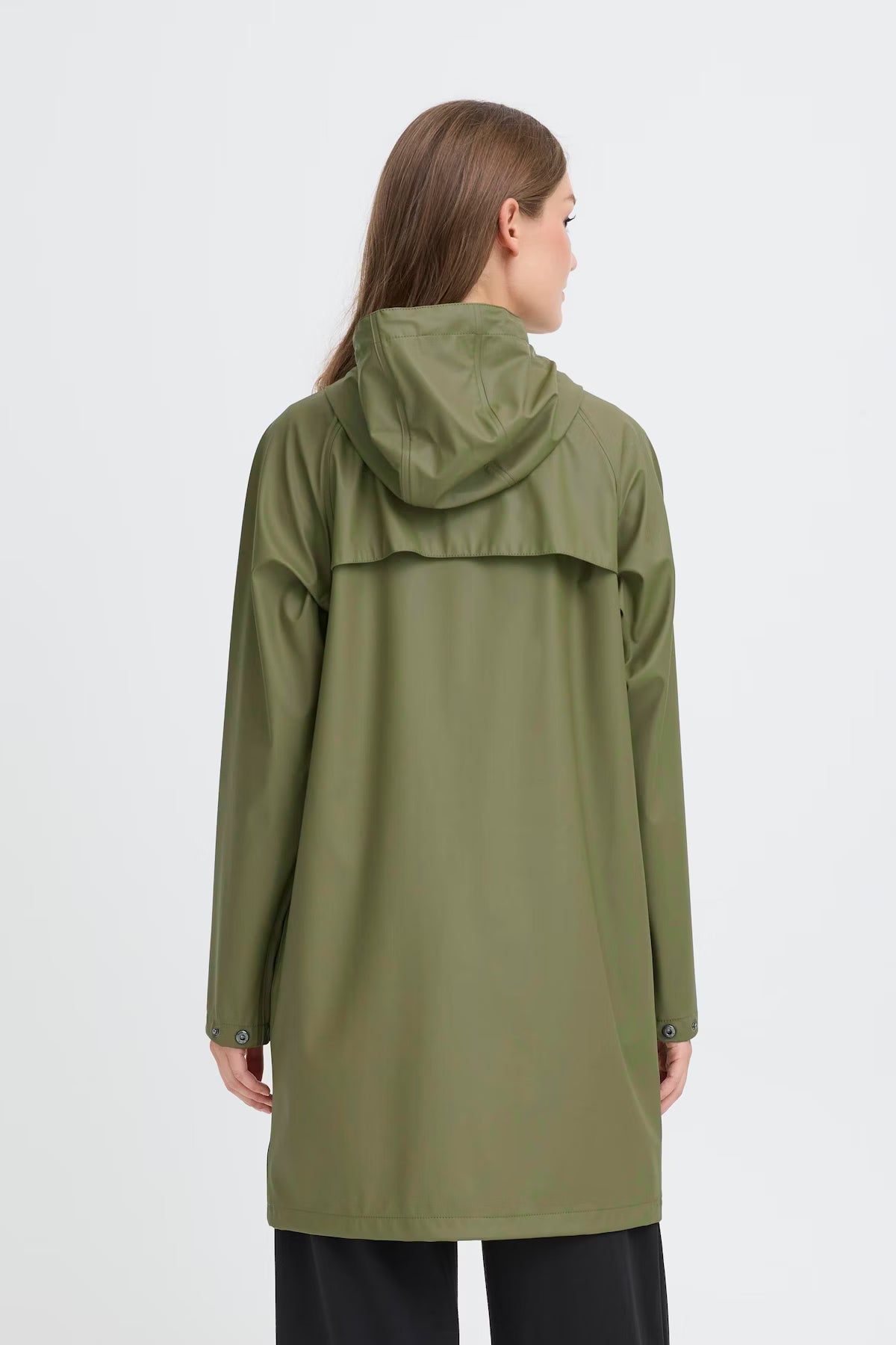 Person wearing a green raincoat on a white background
