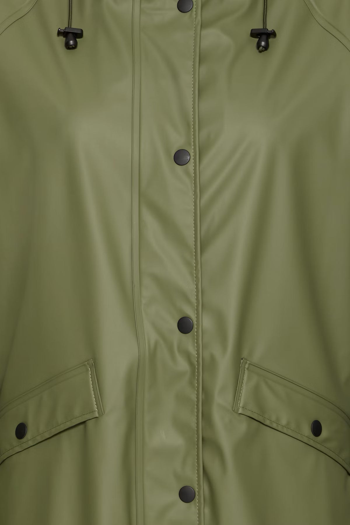 Close-up of a green raincoat with buttons and a hood.