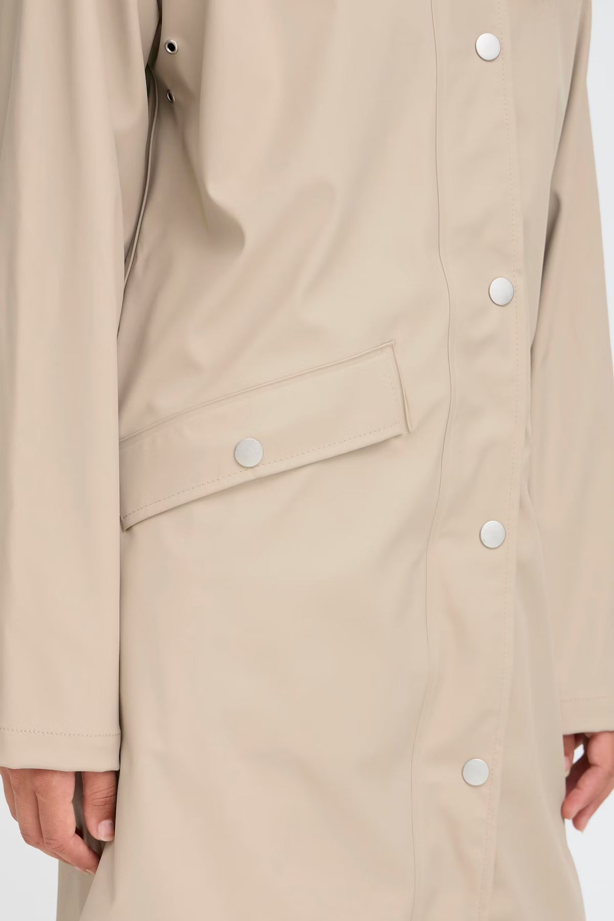 Beige coat with button details on a white background