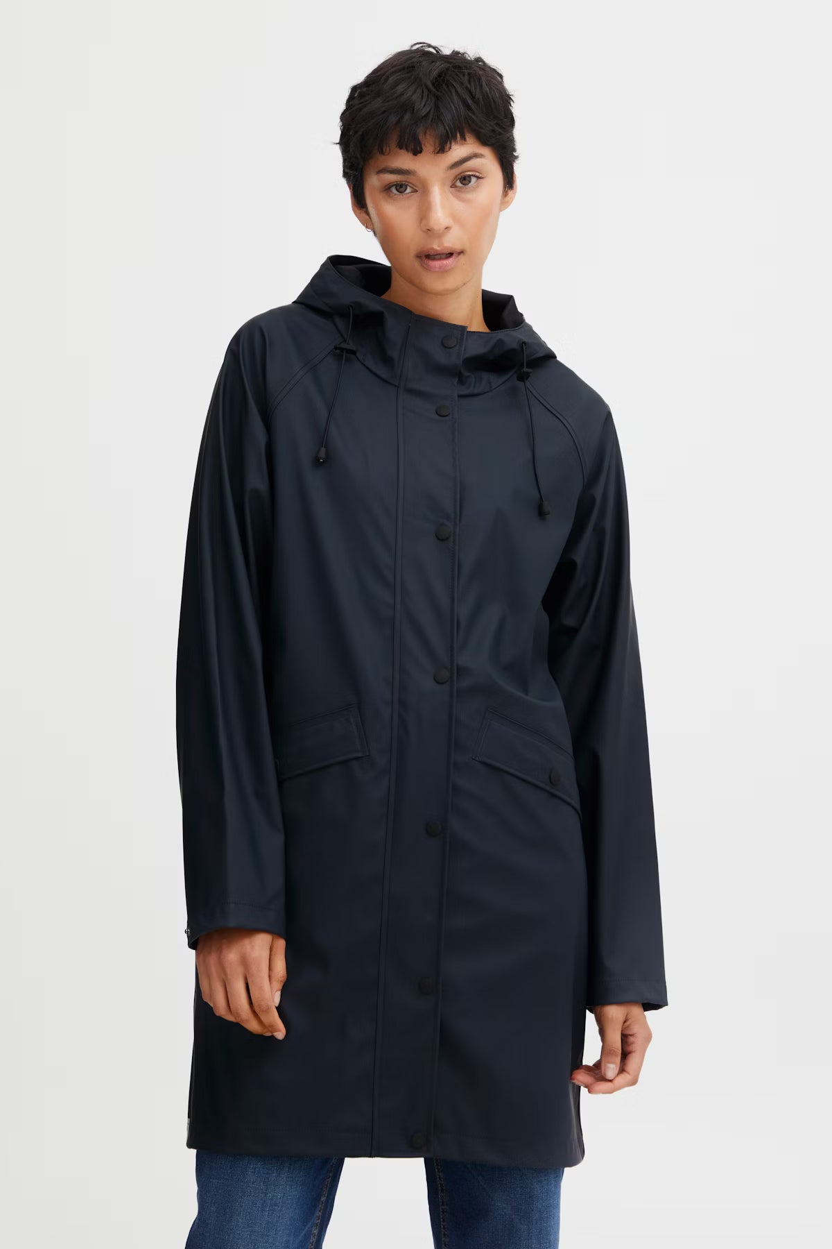 Person wearing a dark blue raincoat on a white background