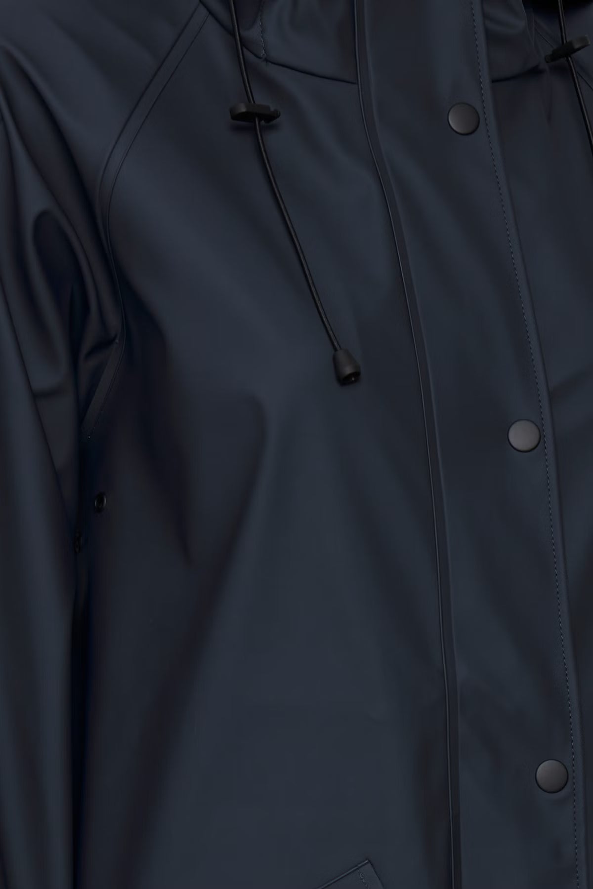 Close-up of a dark blue raincoat with buttons and a hood.