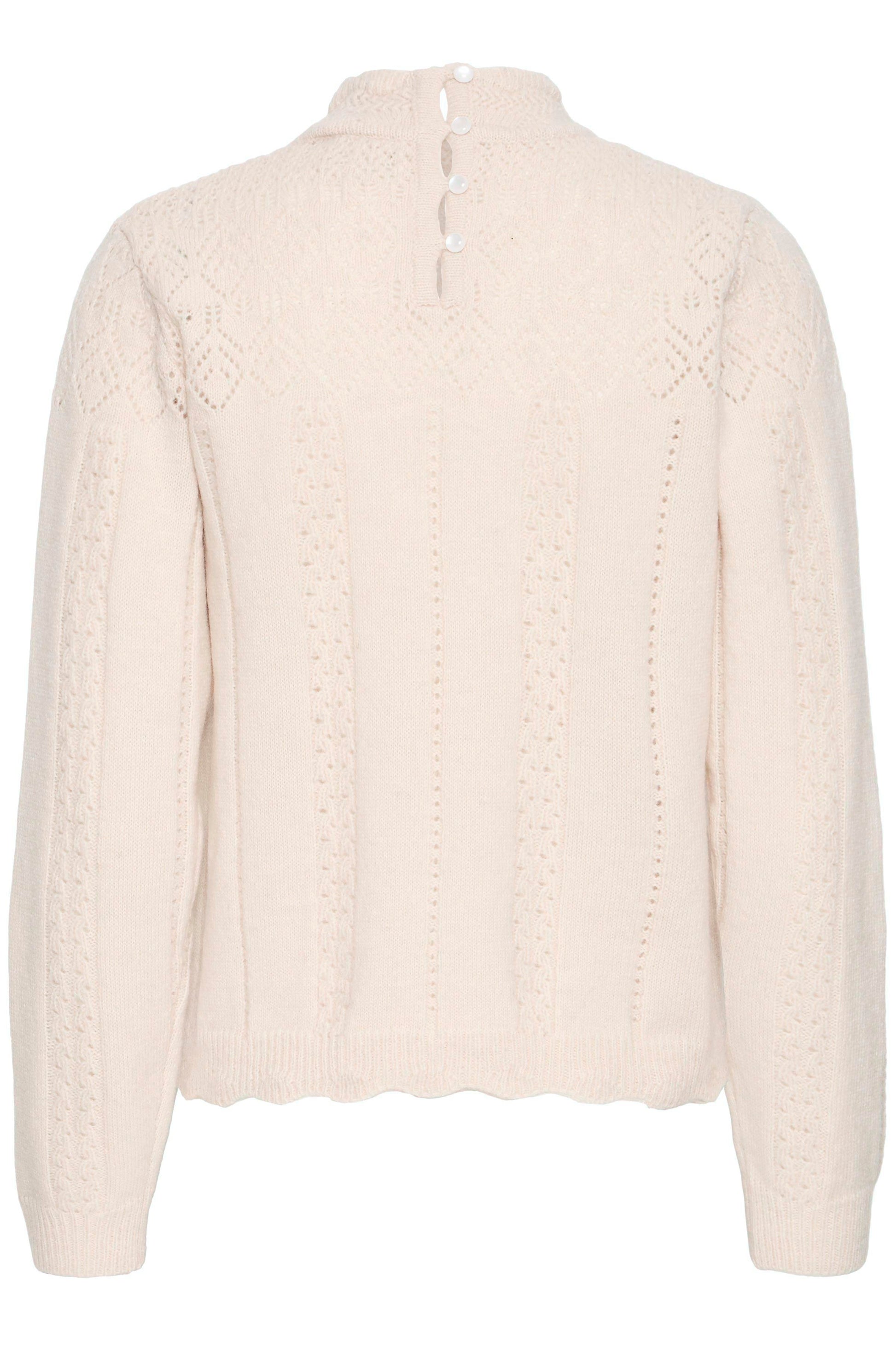 Beige cable knit sweater on a white background
