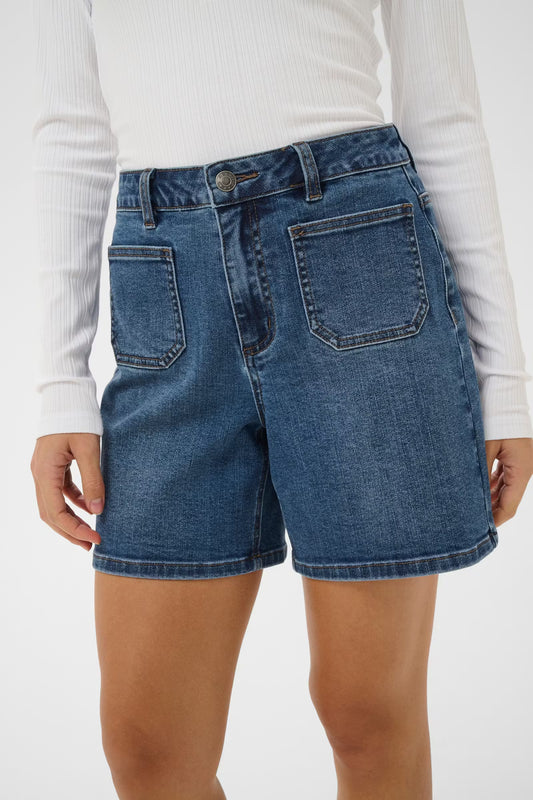 Person wearing blue denim shorts on a white background