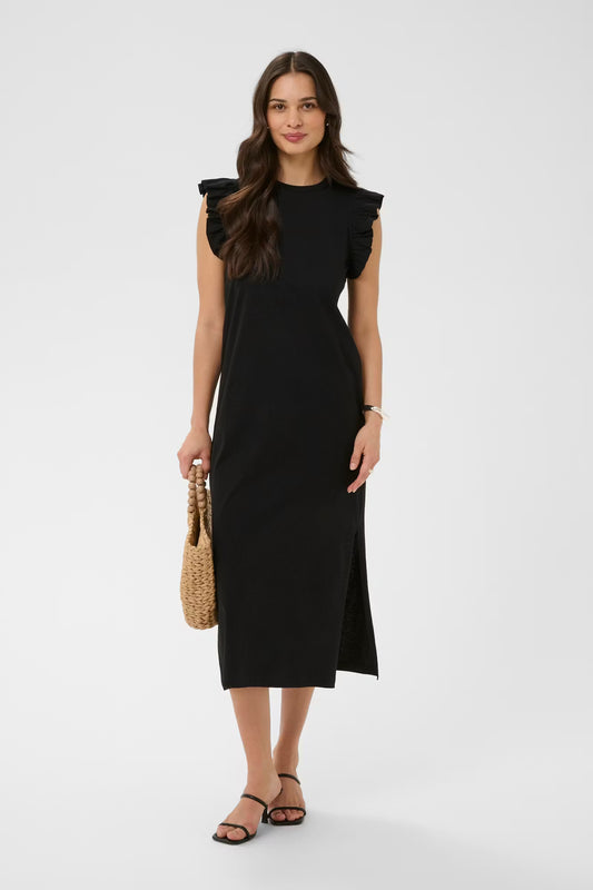Woman wearing a black dress holding a woven handbag on a white background