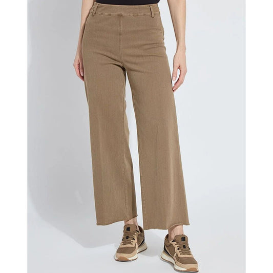 Person wearing beige wide-leg pants on a white background