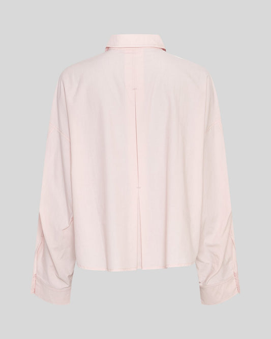 Light pink shirt on a neutral background