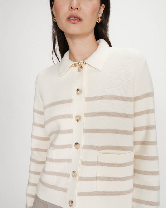 Woman wearing a cream and beige striped cardigan on a white background