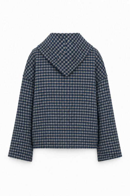A cropped, long-sleeve jacket with a wide collar, featuring a navy blue and beige gingham check pattern, shown against a plain white background.