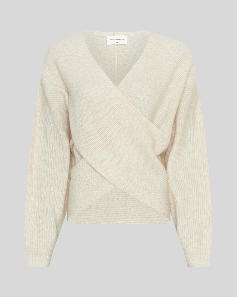 Cream-colored ribbed sweater on a light gray background