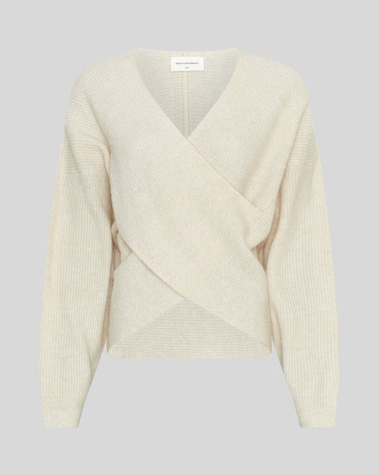 Cream-colored ribbed sweater on a light gray background