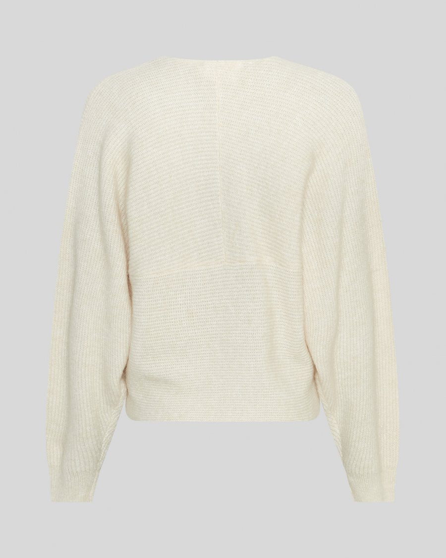 Cream-colored sweater on a light gray background