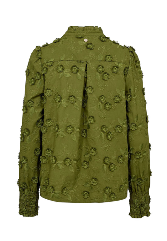 An olive green textured jacket with 3D floral appliques and ruffled trim on the sleeves and shoulders, shown from the back against a plain white background.