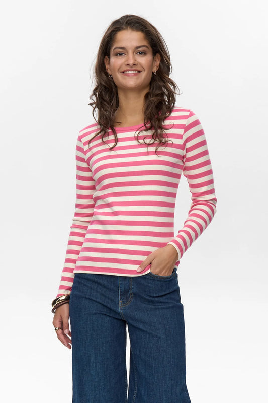 Woman wearing a pink and white striped long-sleeve shirt with blue jeans on a white background