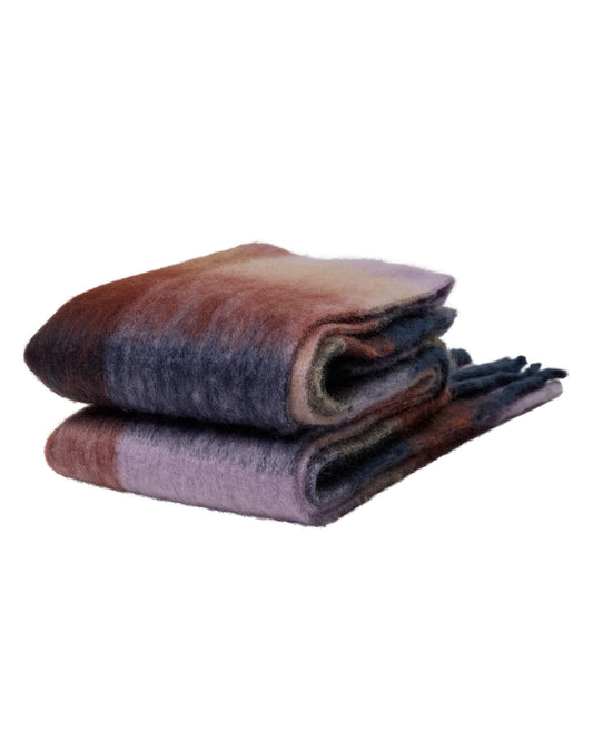 Folded multicolored blanket on a white background