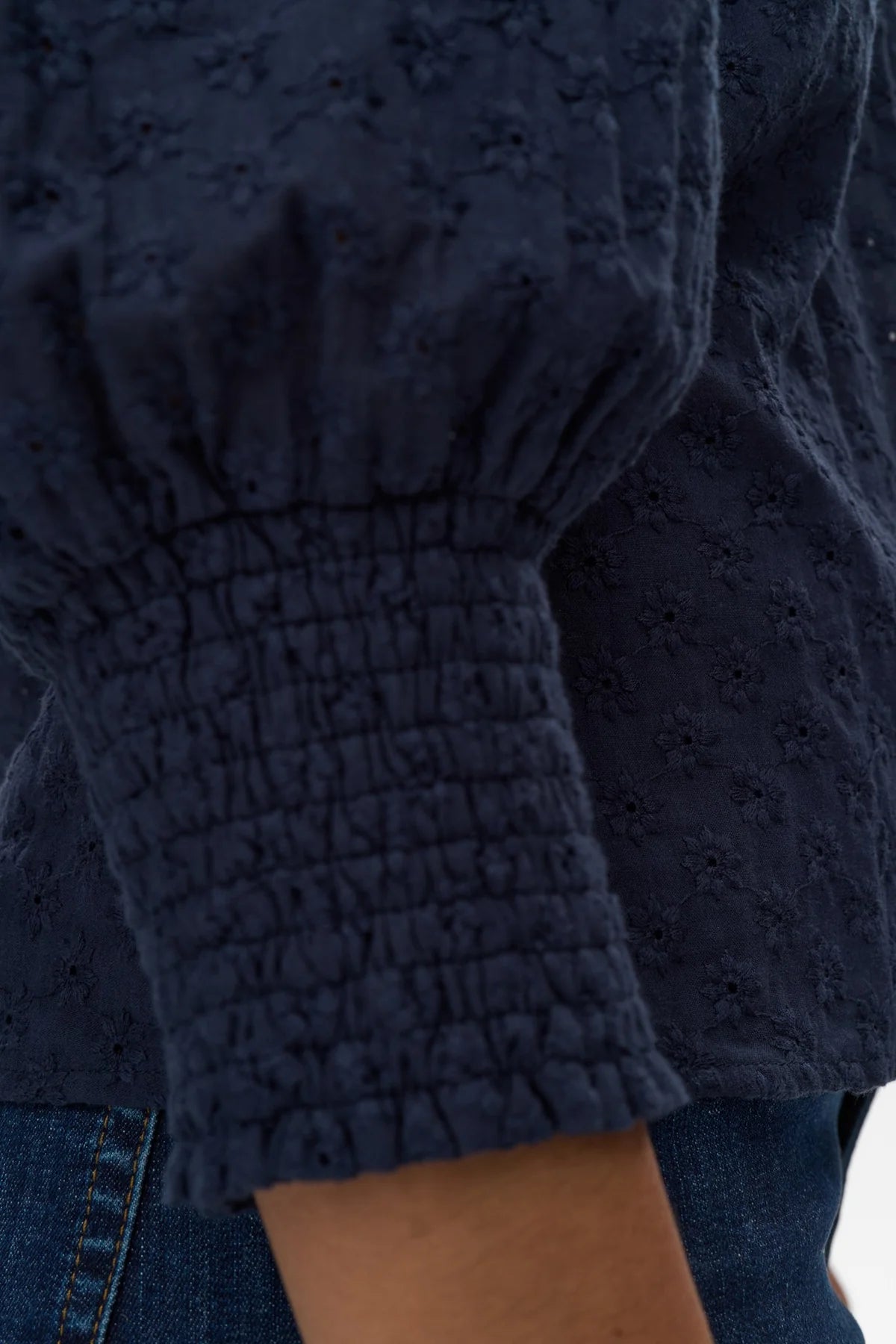 Close-up of textured navy blue fabric with a blurred background