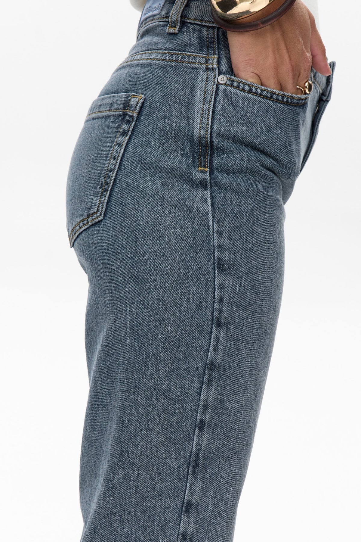Close-up of blue jeans on a white background