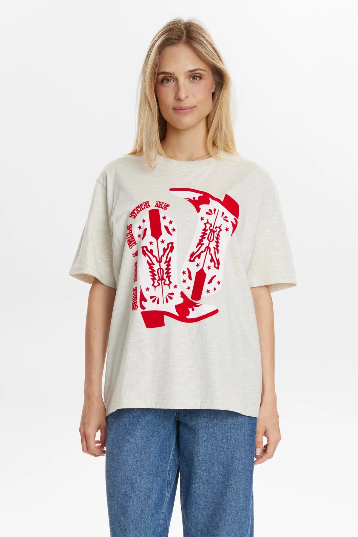 Woman wearing a white t-shirt with a red graphic design on a plain background