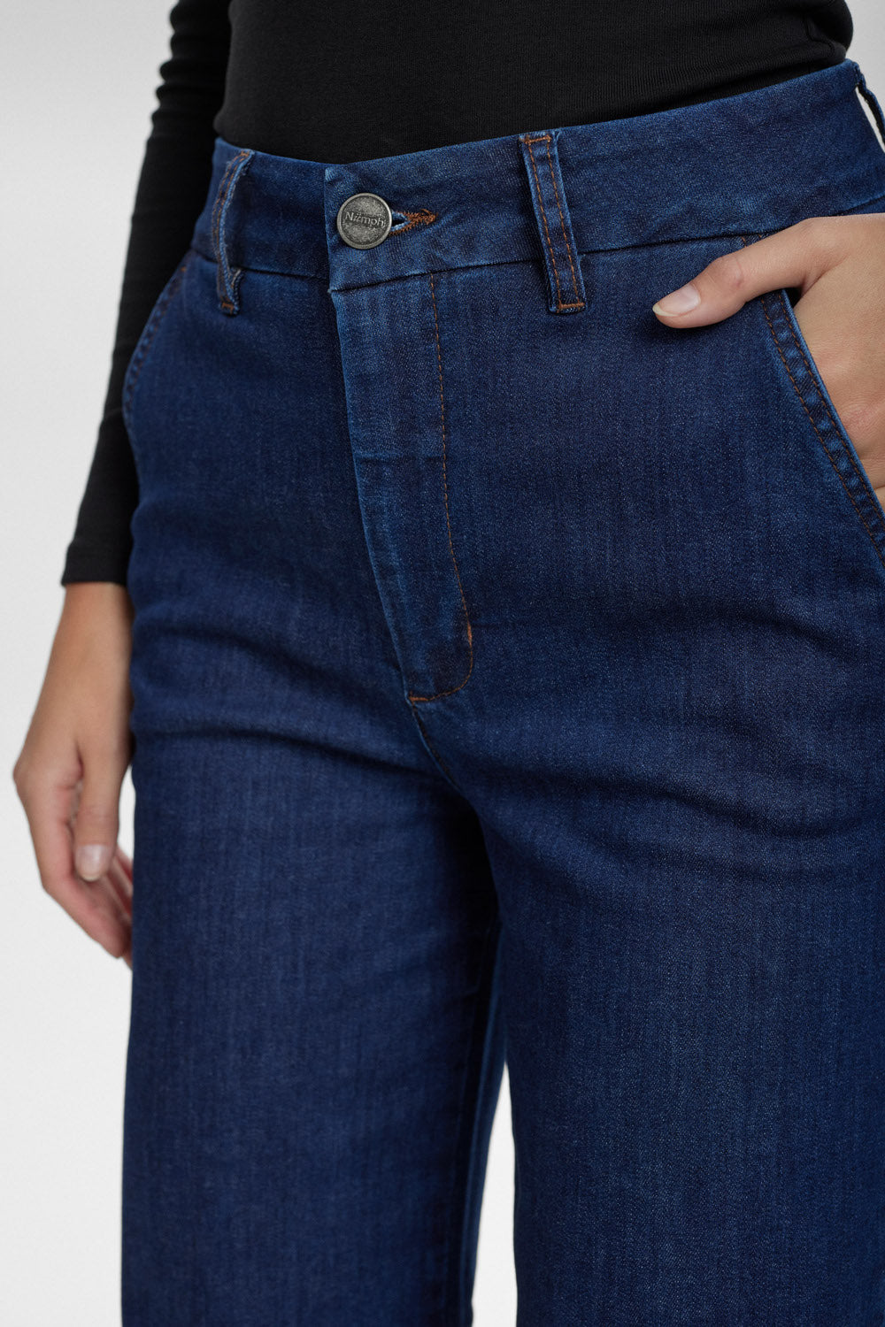 Close-up of blue jeans with a plain background