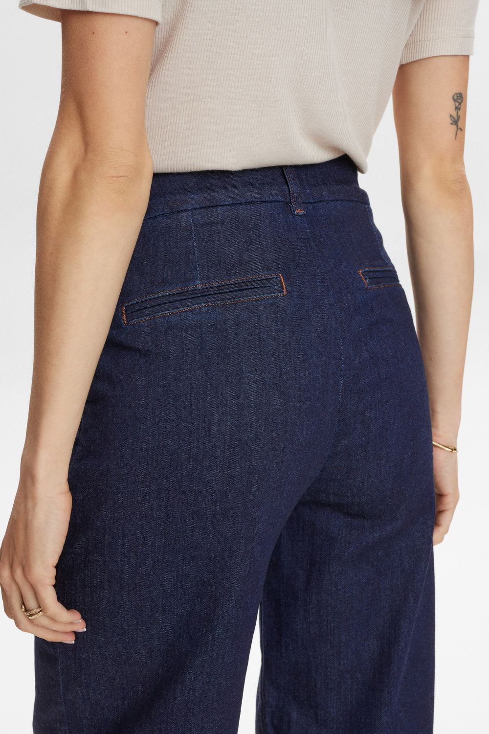 Navy blue pants worn by a person on a white background
