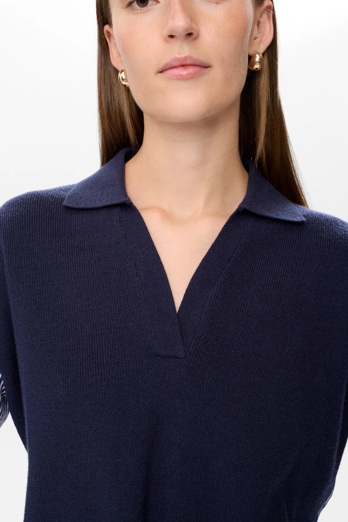 Navy blue sweater worn by a person on a white background