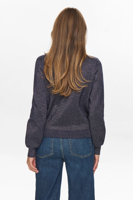 Person wearing a dark gray sweater and blue jeans on a white background