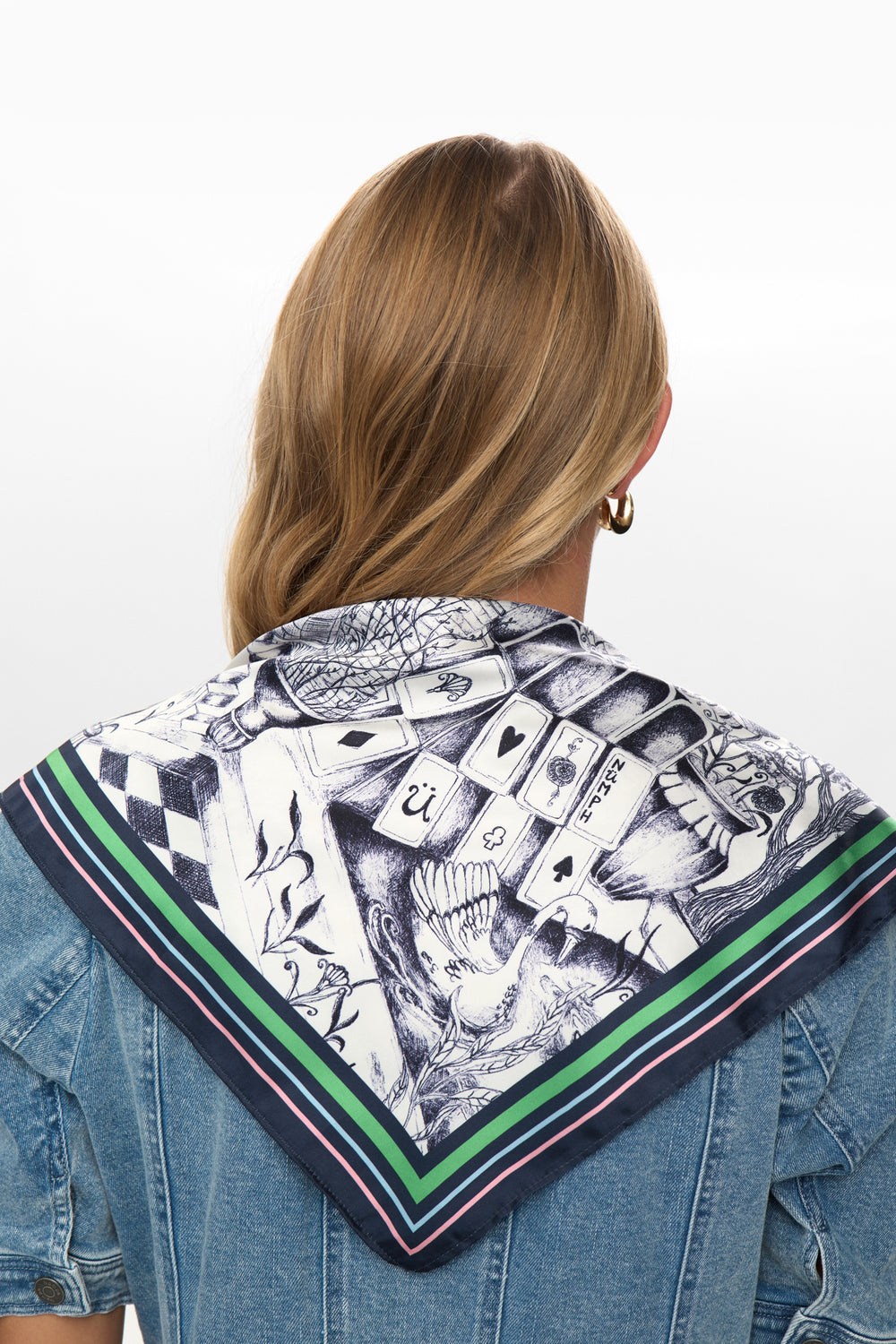 Person wearing a patterned scarf on a white background