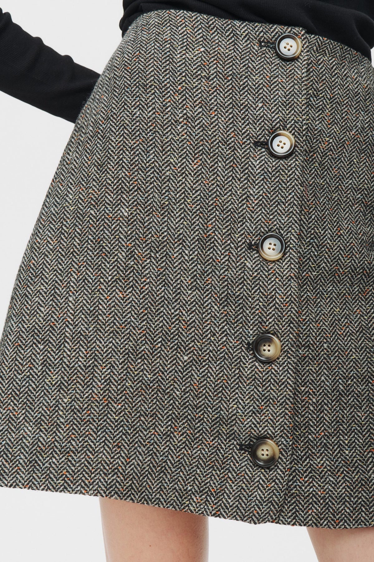 Gray herringbone skirt with button details on a white background