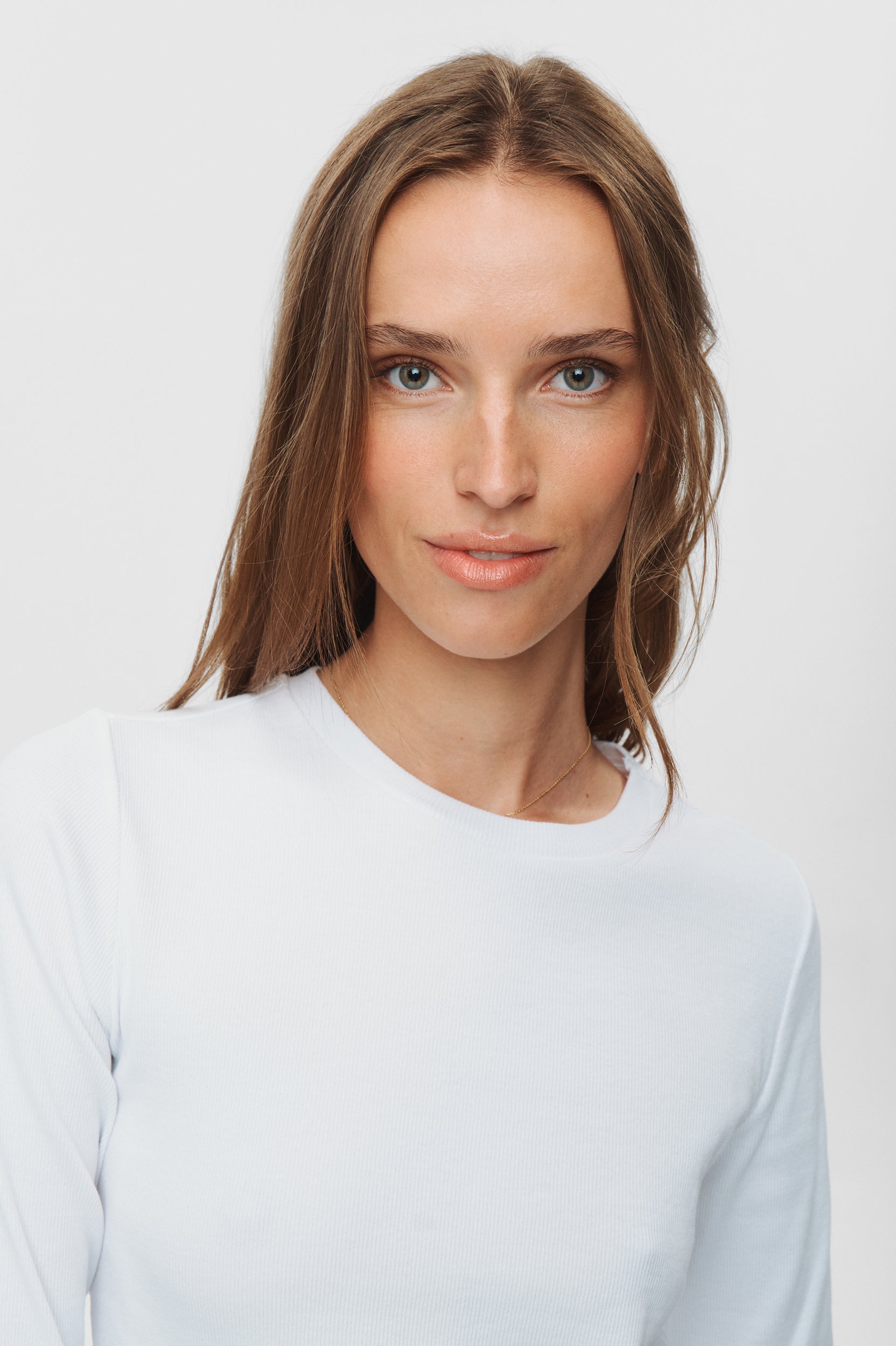 Woman wearing a light blue shirt against a white background