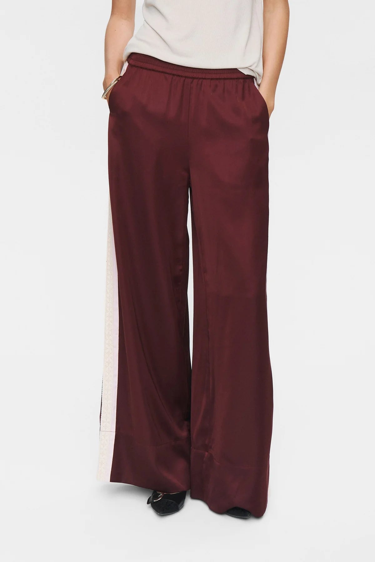 Maroon wide-leg pants worn by a person on a white background