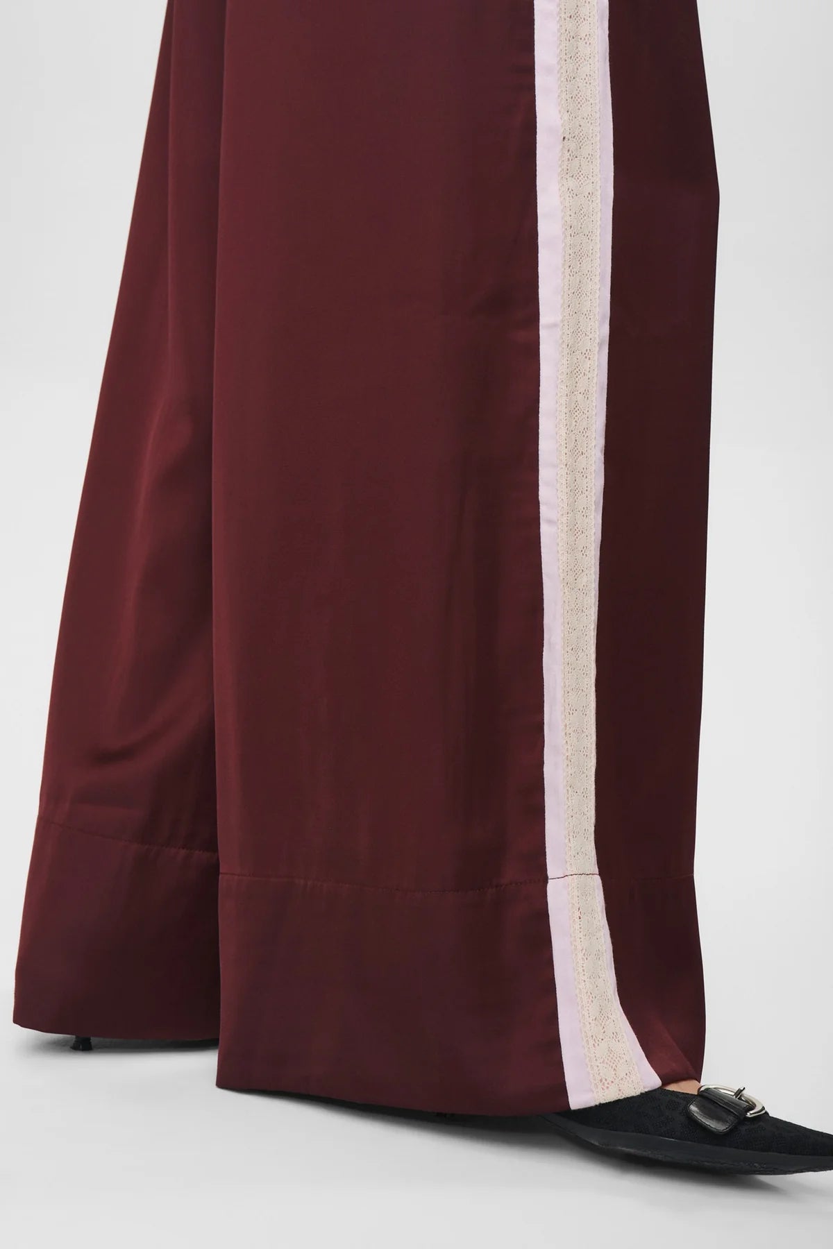 Maroon pants with a white stripe on a white background