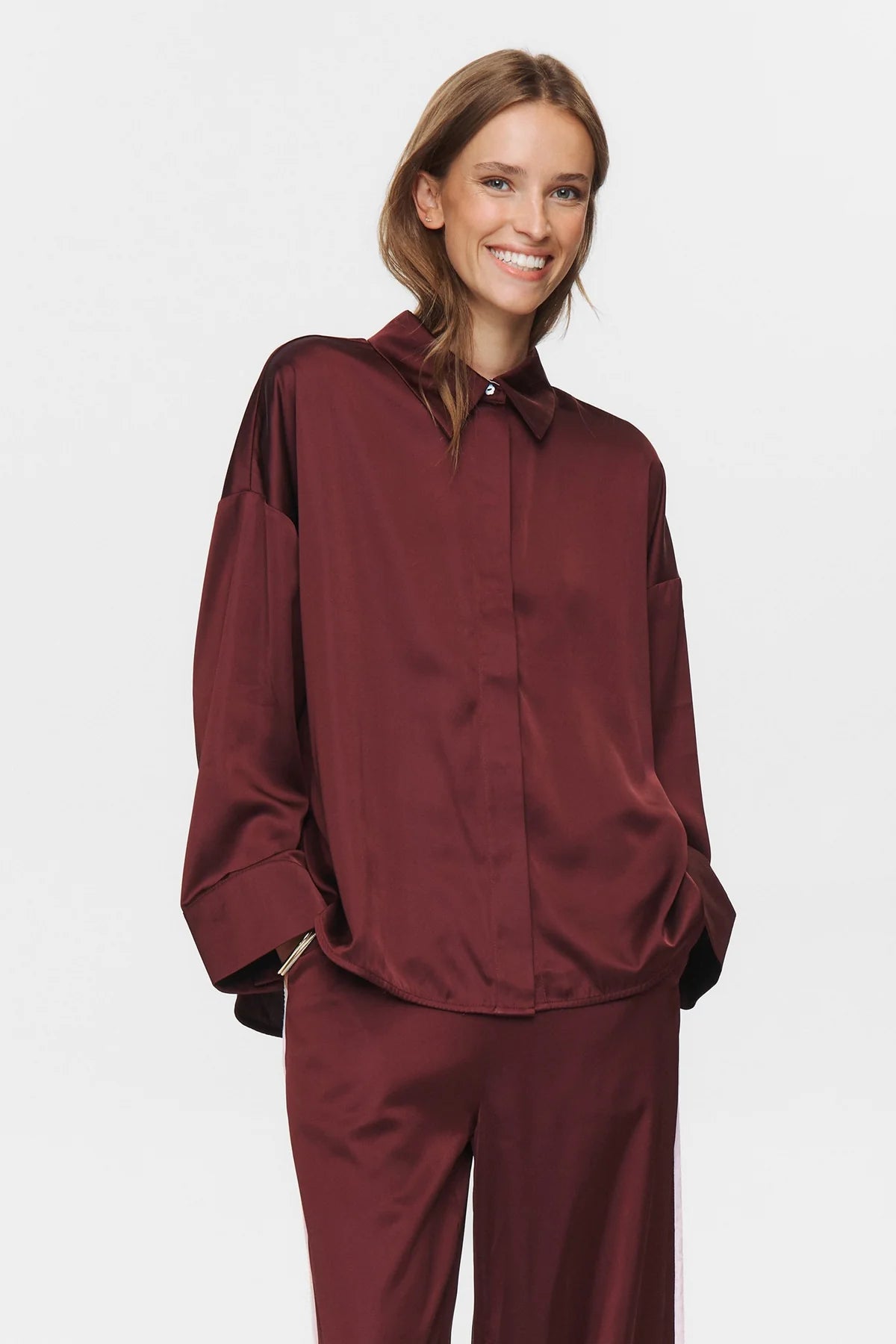 Woman wearing a burgundy outfit on a white background
