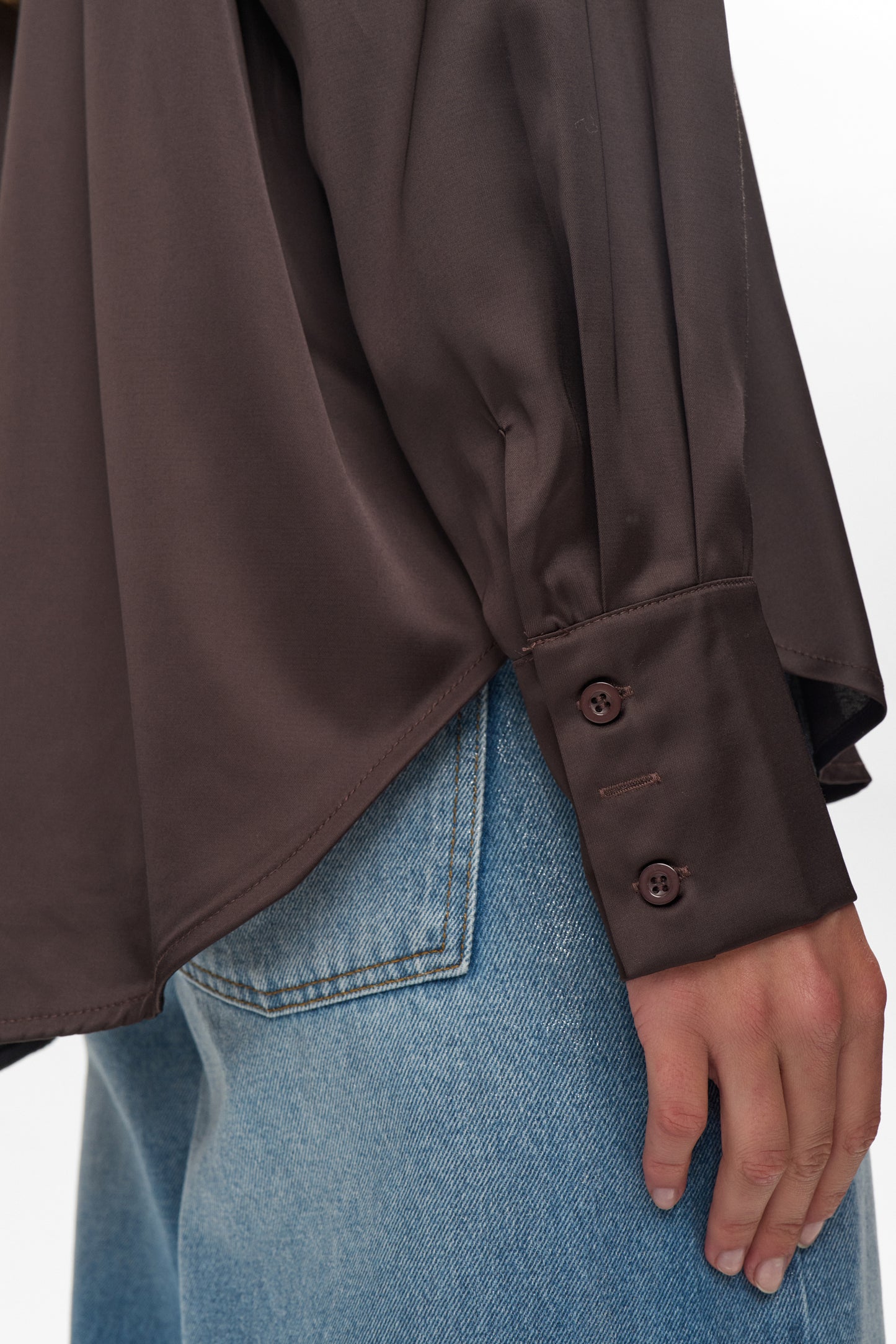 Brown shirt and blue jeans on a white background