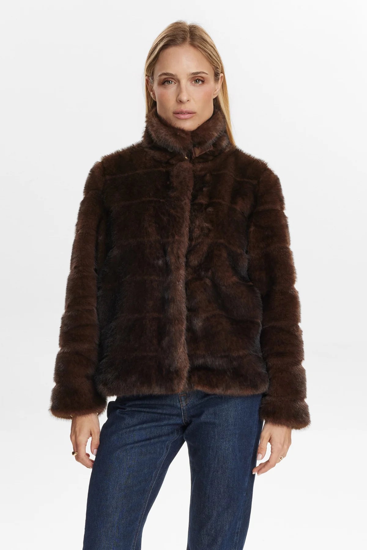 Woman wearing a brown fur coat on a white background