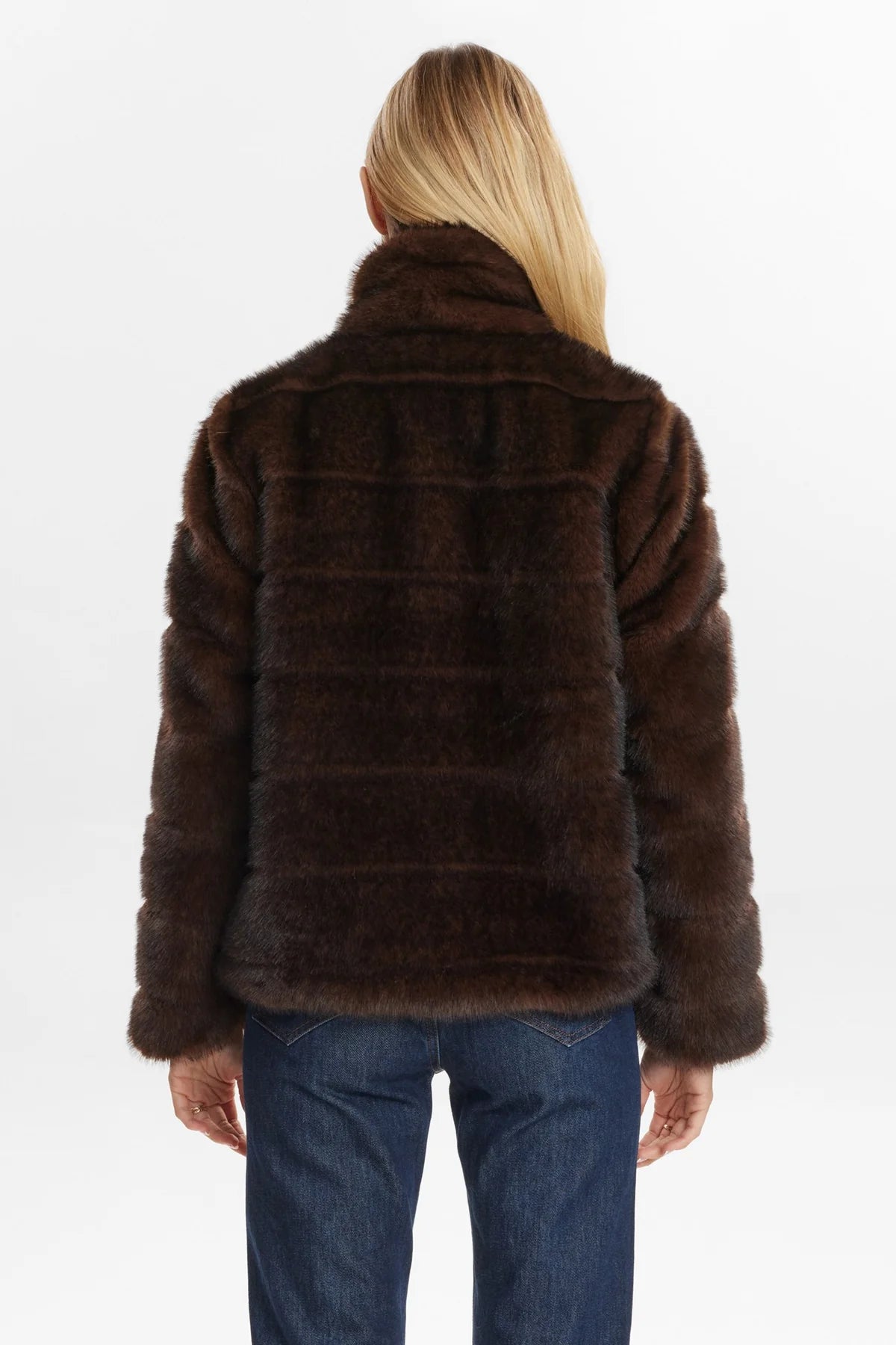 Brown fur jacket worn by a person on a white background